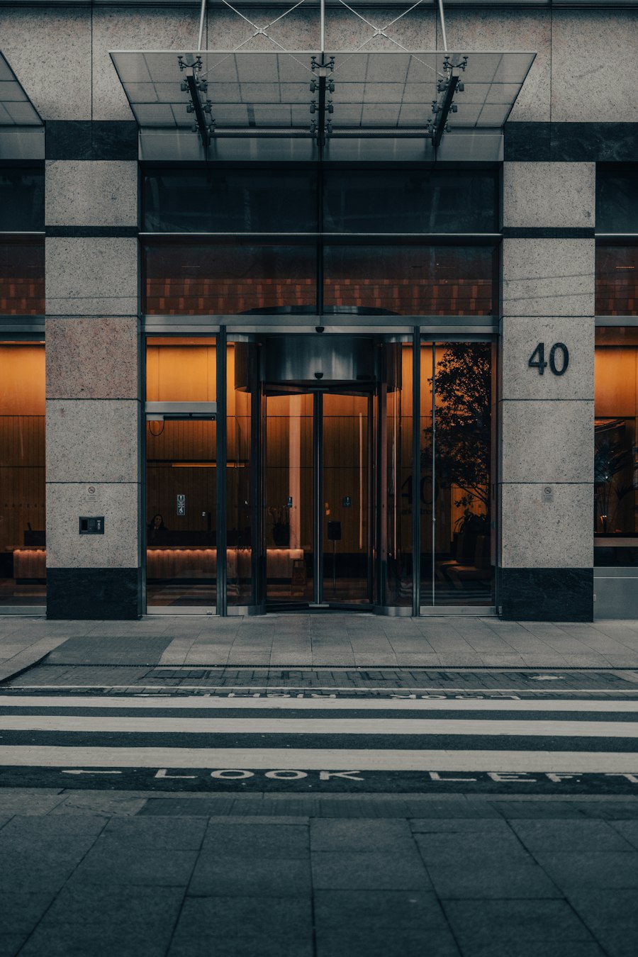 Glass entrance of a commercial building with a revolving door