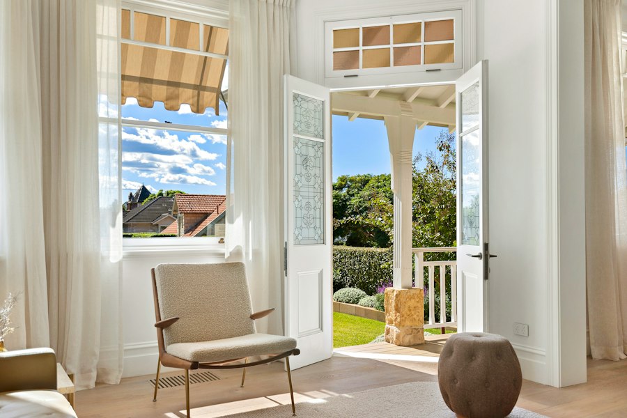 Open glazed patio doors leading to a sunny backyard